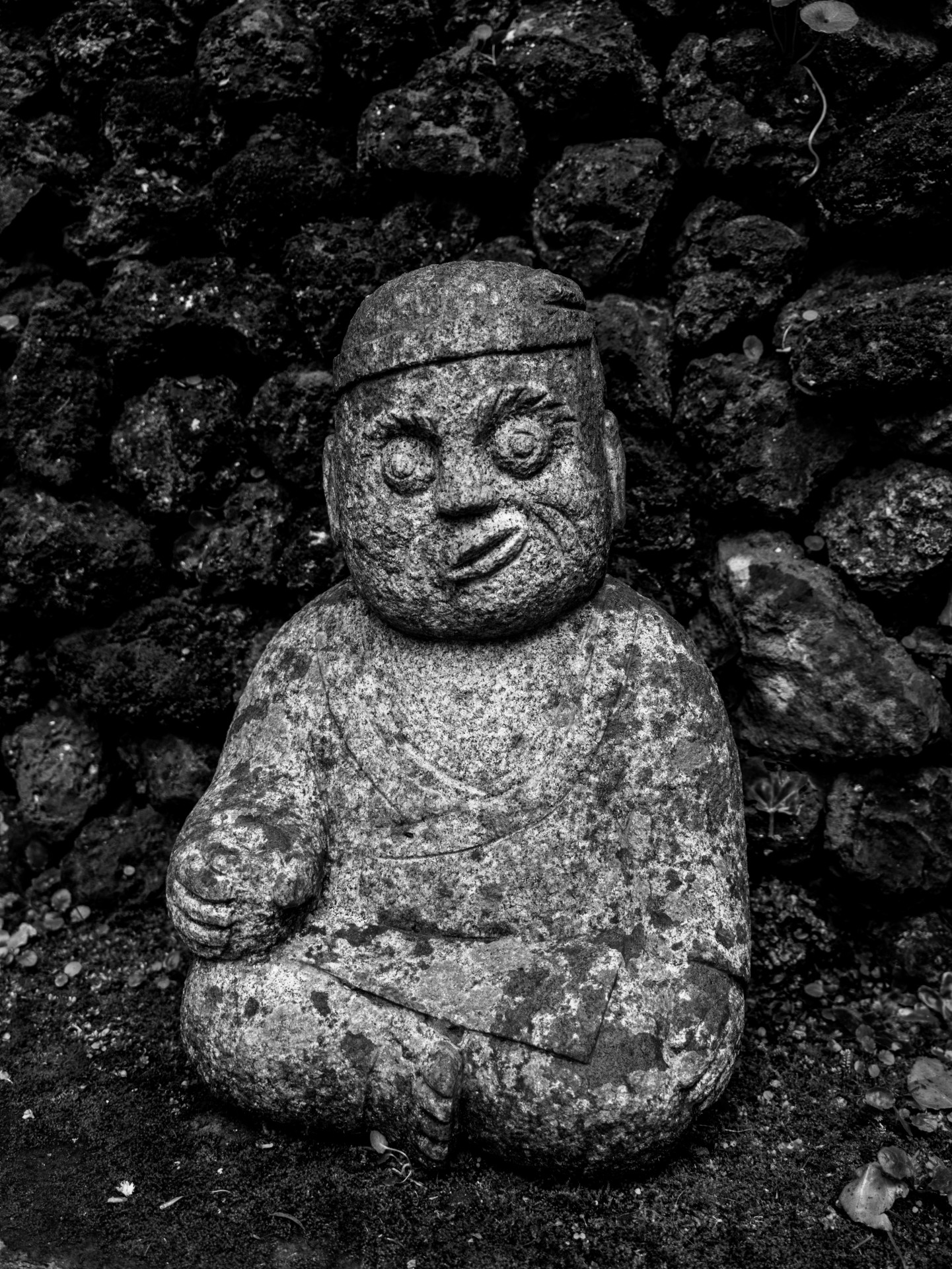 Weathered Stone Monk Statue at Monte Palace Tropical Garden