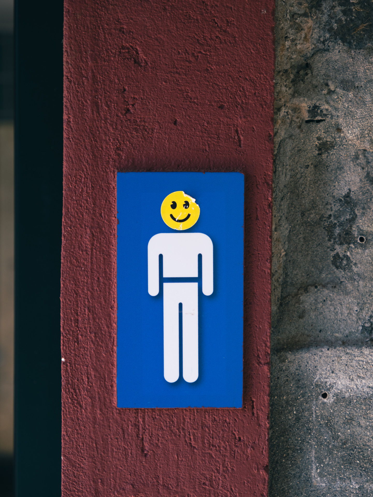 Men's Restroom Sign with Smiley Sticker in Funchal