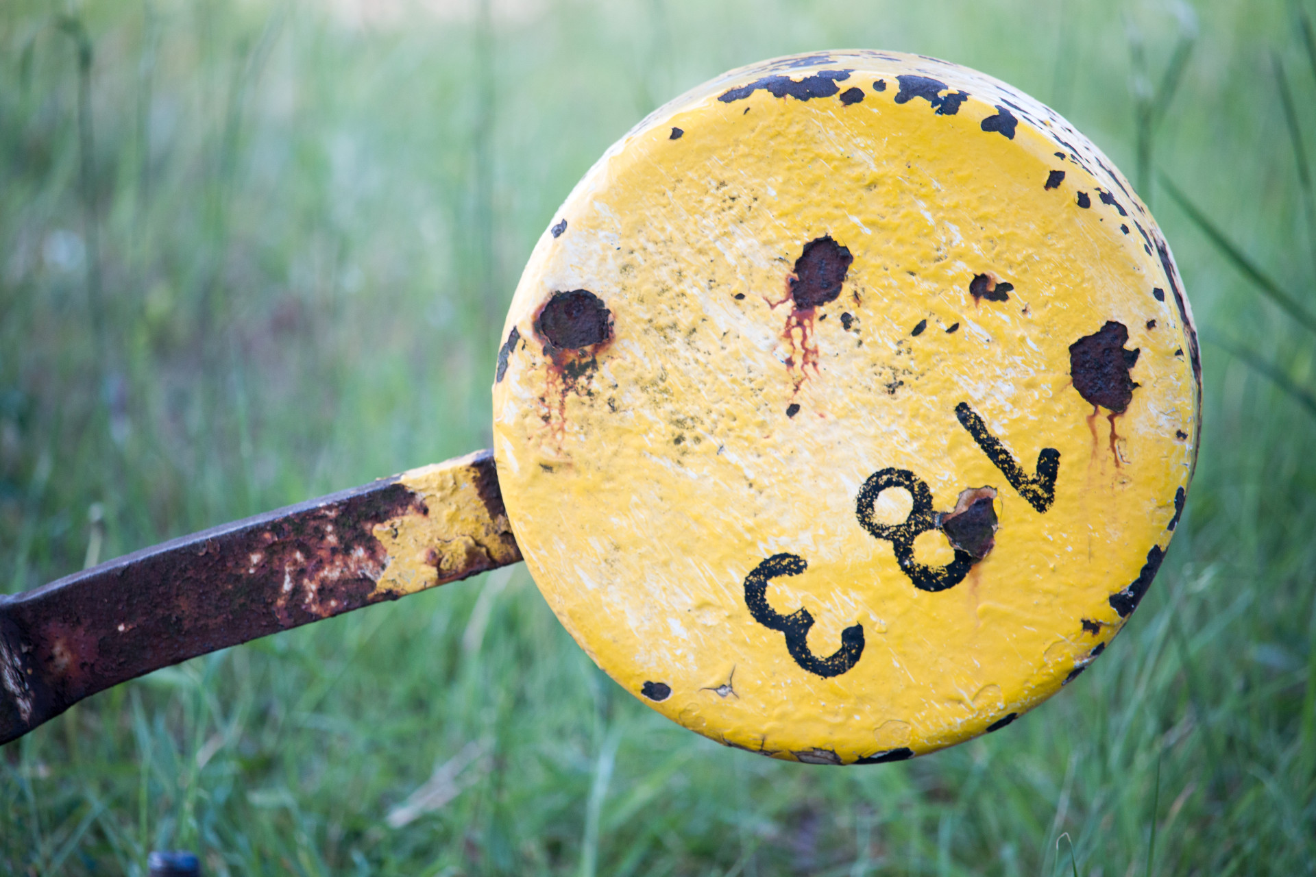 Rusty Yellow Metal Signpost